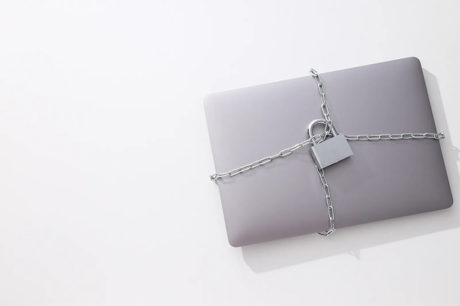 Laptop wrapped in a chain and padlock