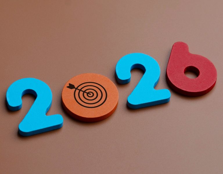 Foam numbers and a target symbol arranged to represent "2026" on a brown background, hinting at digital marketing trends small businesses may follow in the coming year. - Kemoso